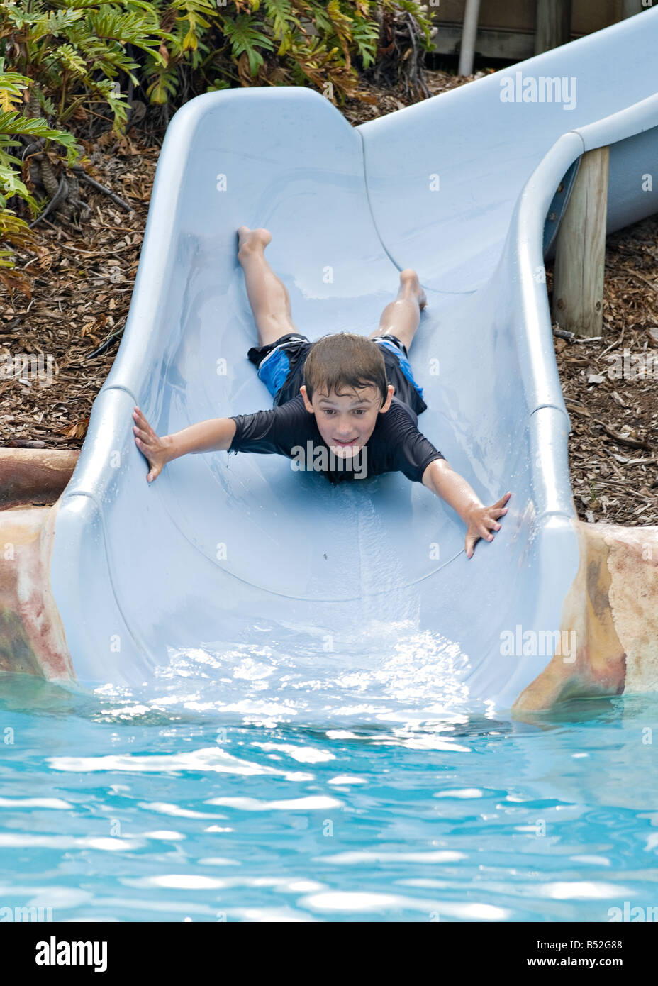 adventurous-boy-comes-down-the-slide-head-first-B52G88.jpg