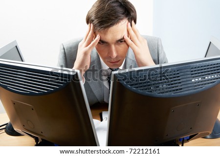 stock-photo-image-of-businessman-touching-his-head-while-looking-at-monitor-with-tired-expression-72212161.jpg