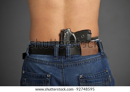 stock-photo-man-s-back-with-gun-tucked-in-pants-isolated-on-white-background-92748595.jpg